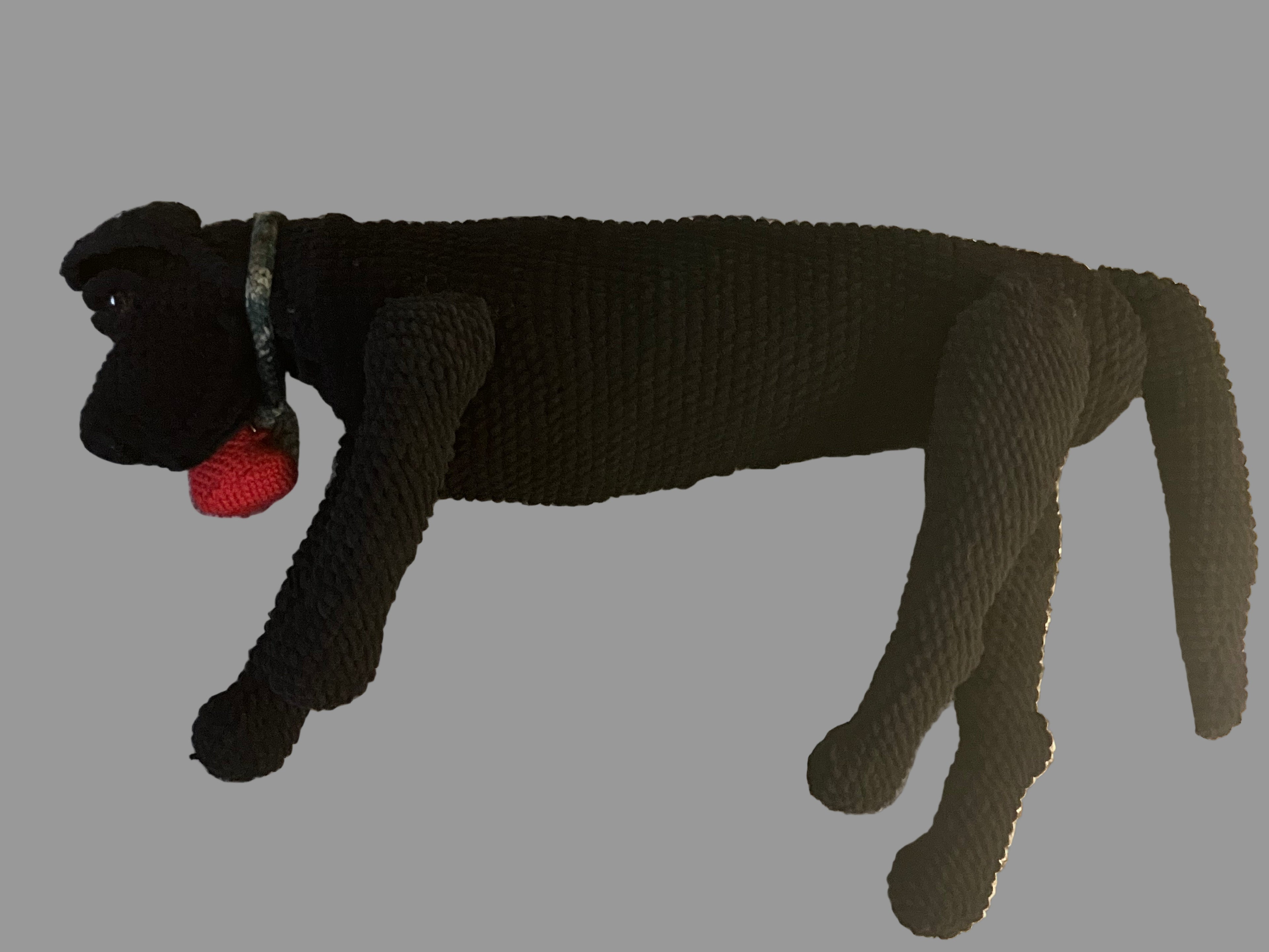 Black full-size crocheted dog plush with dog collar and heart-shaped voice recorder.